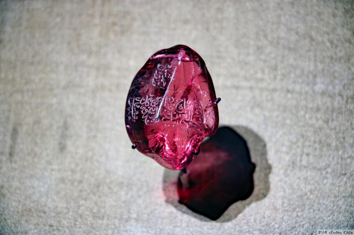A single ruby gemstone with an inscription relating to Indian royalty on its surface