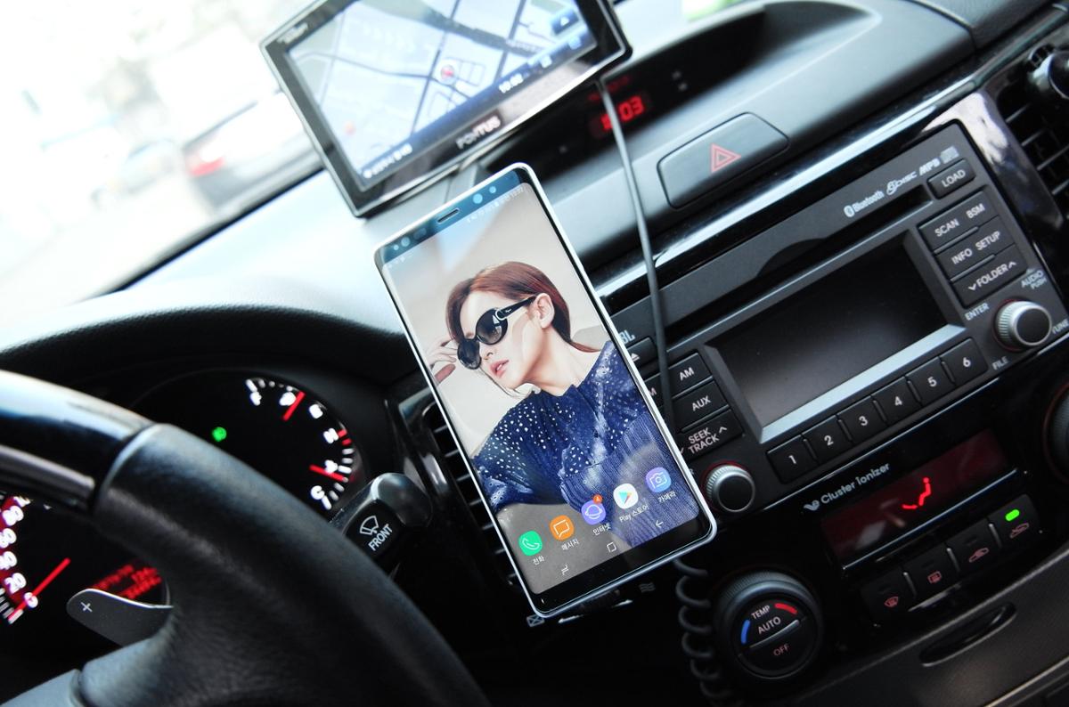A smartphone mounted on a car dashboard