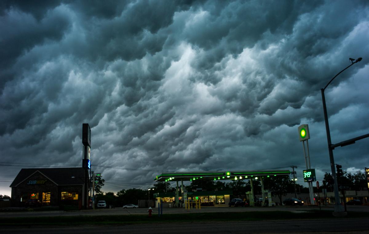 Rolling storm clouds start to form in the sky above a gas station