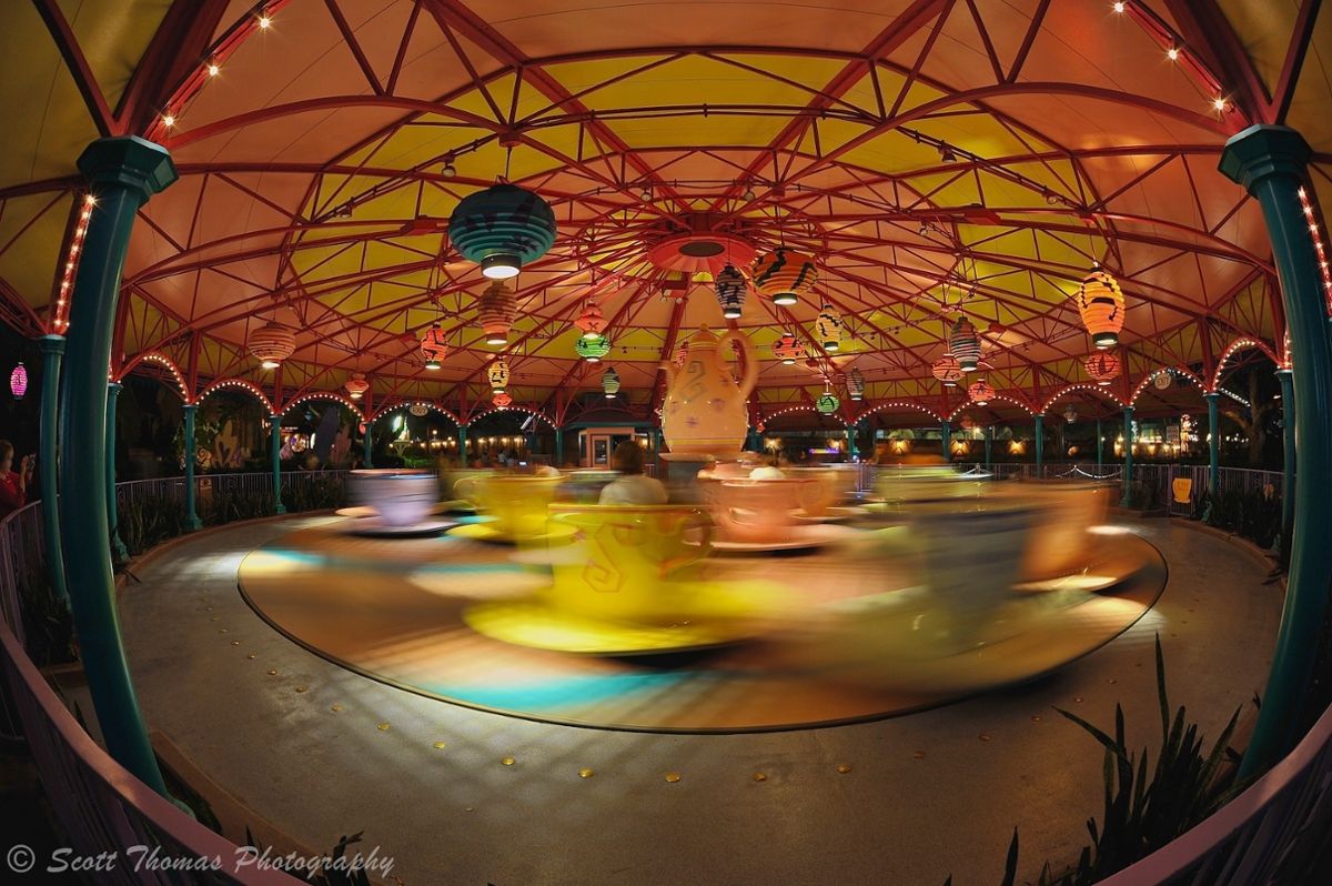 A wide angle view of a spinning teacup ride with lots of colors