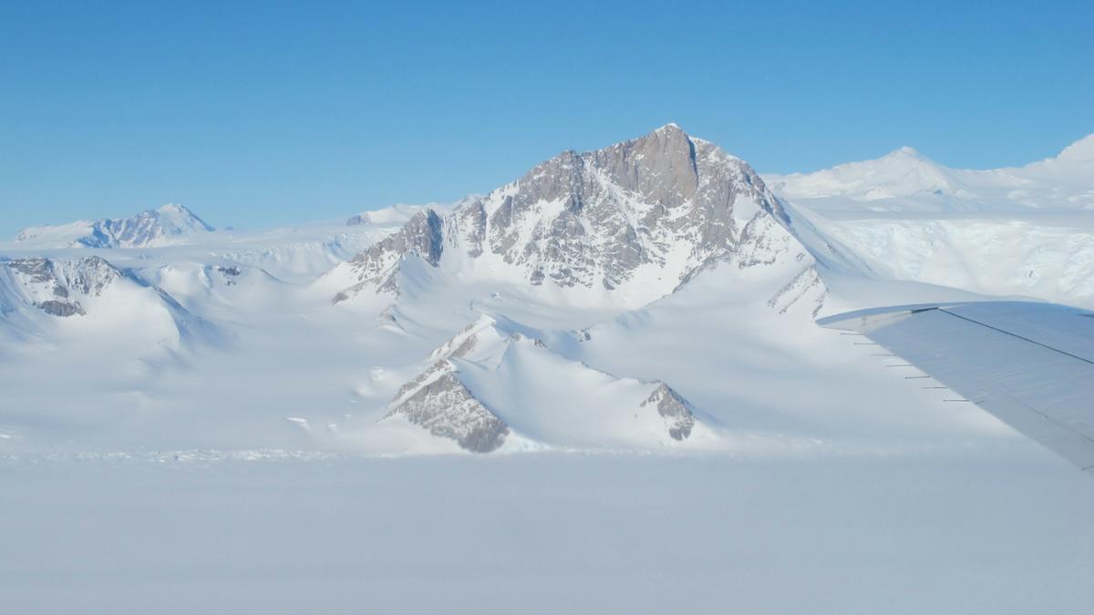 A view of several mountain peaks in the arctic as seen from a plane