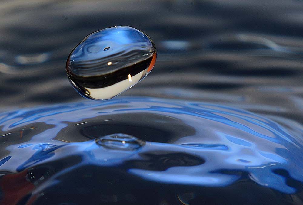 A water drop above the water's surface