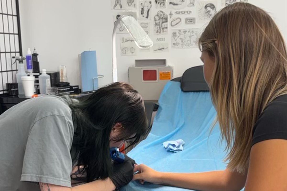 Tattoo artist Clementine Wilson at work