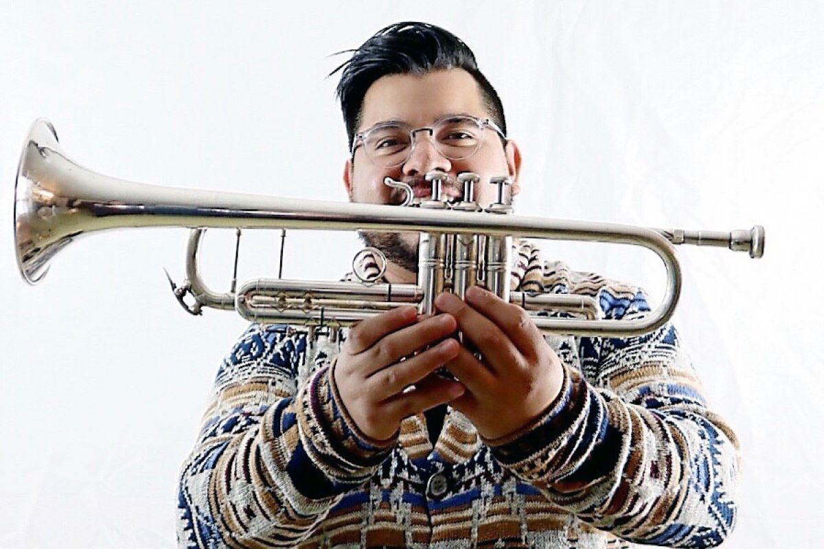 Jonathan De La Cruz poses with his trumpet