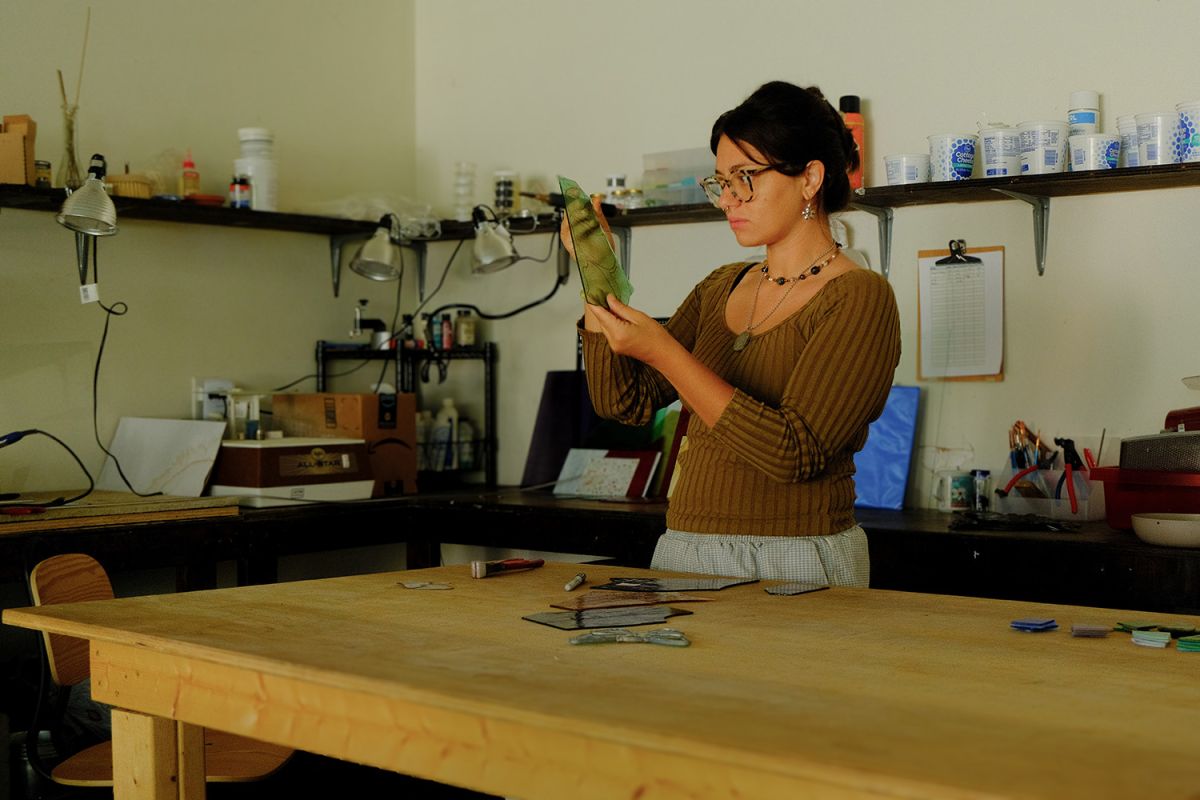 Malory Owen holds a piece of stained glass