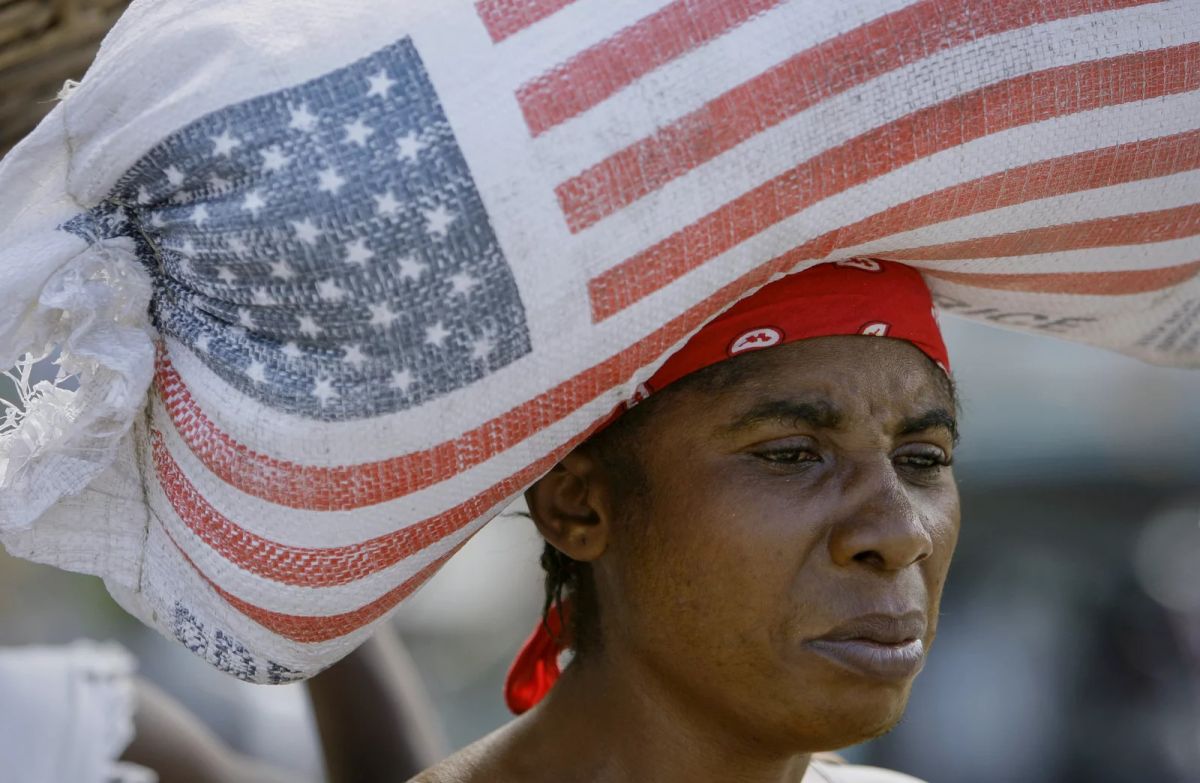 A sad woman with an american flag wrapped around her head