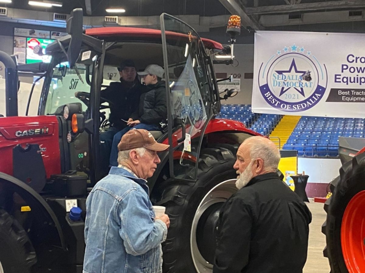 Farmers looking at new tractor 