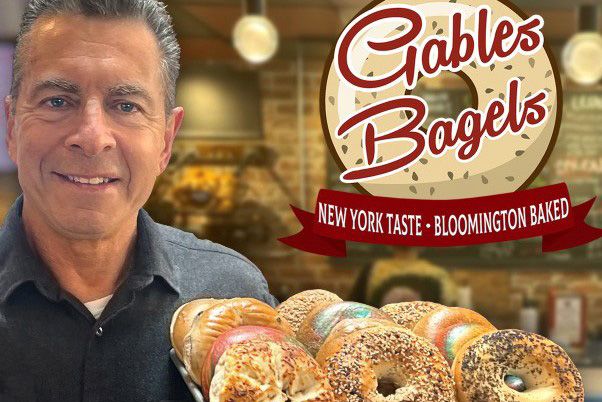 Ed Schwartzman holding a platter of bagels and a Gable's Bagels logo next to him
