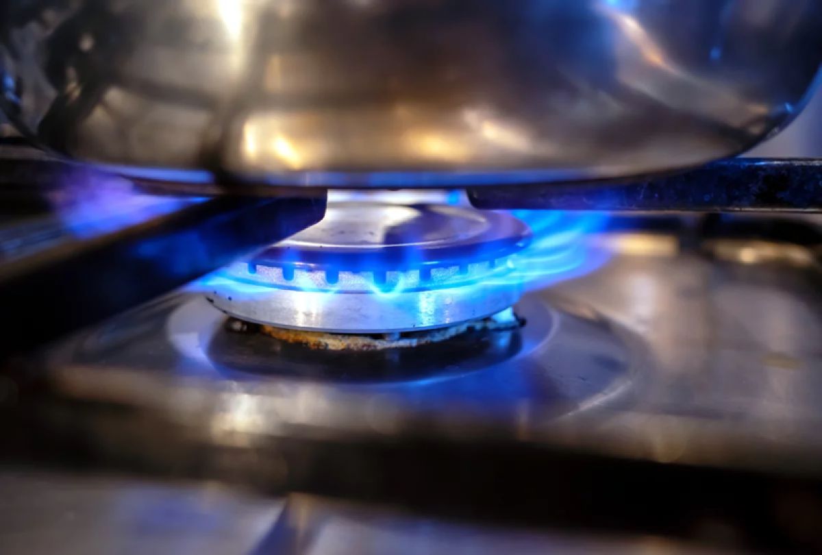 A gas stove heating a pot