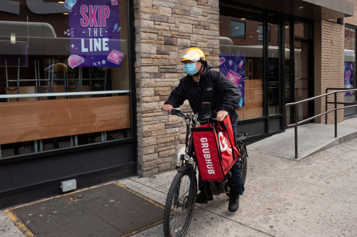 A man delivers Grubhub order on a bike