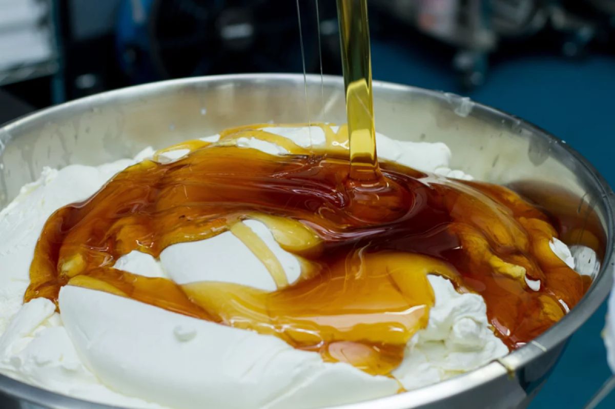 Yogurt being put into a bowl with honey
