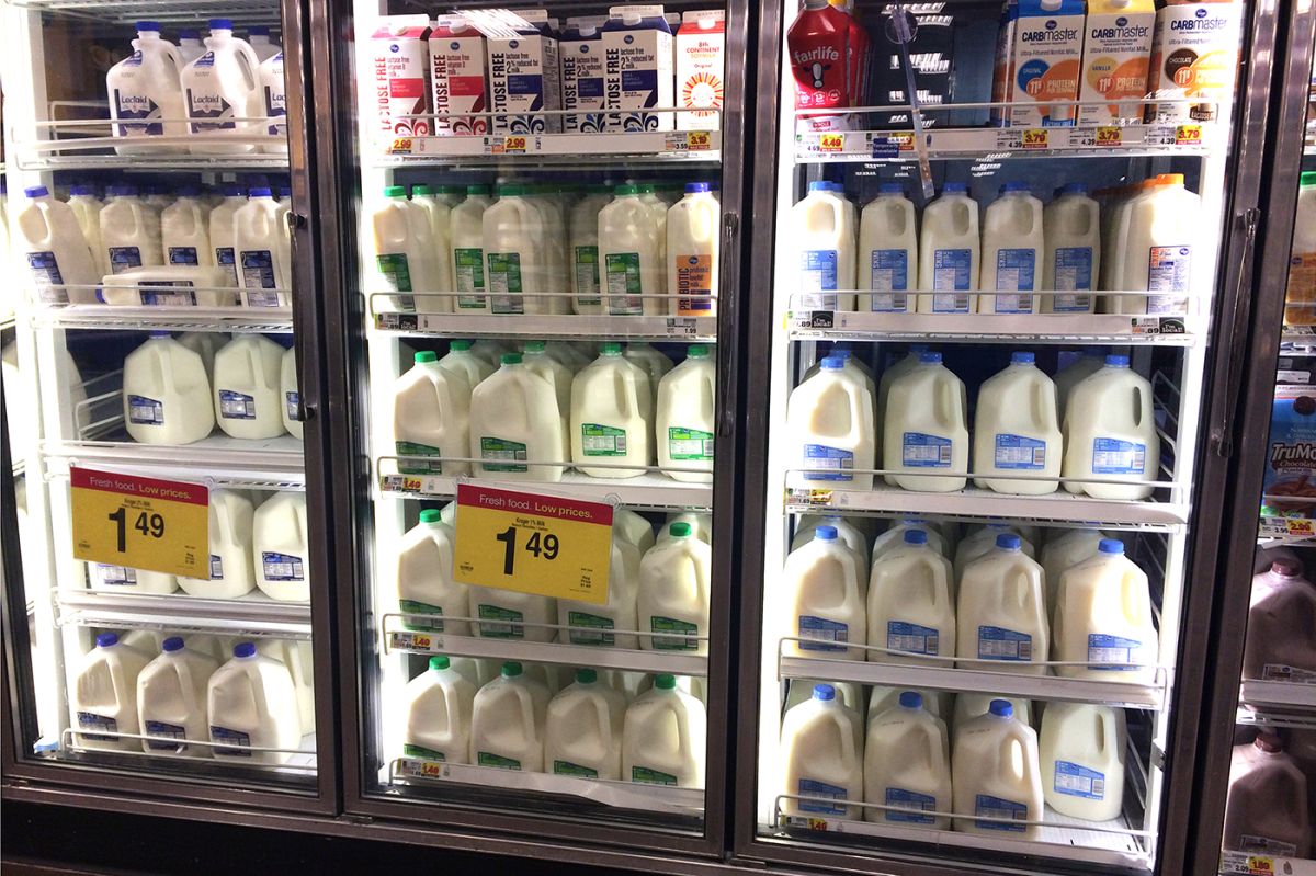 A grocery store reach in cooler filled with milk