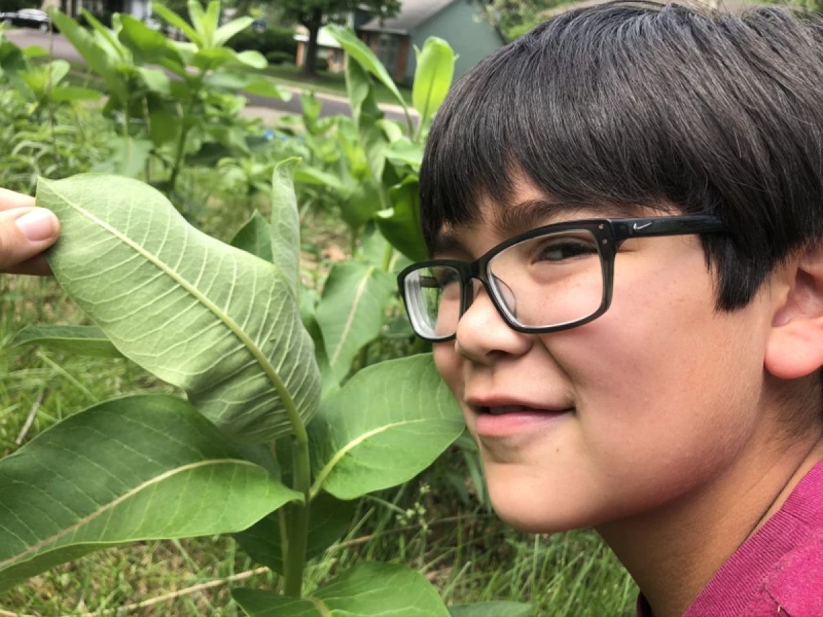 Oliver Hernandez posing with milkweed 