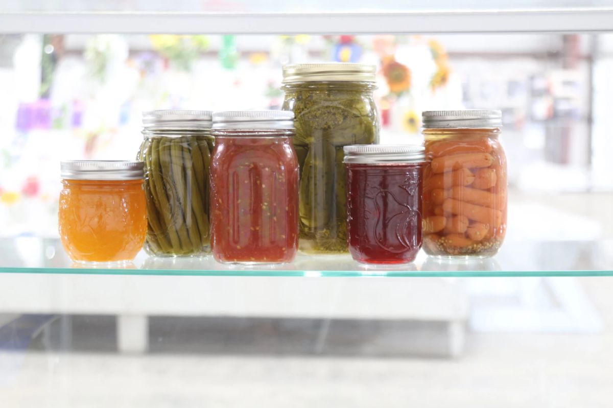 A collection of canned produce on a fridge shelf