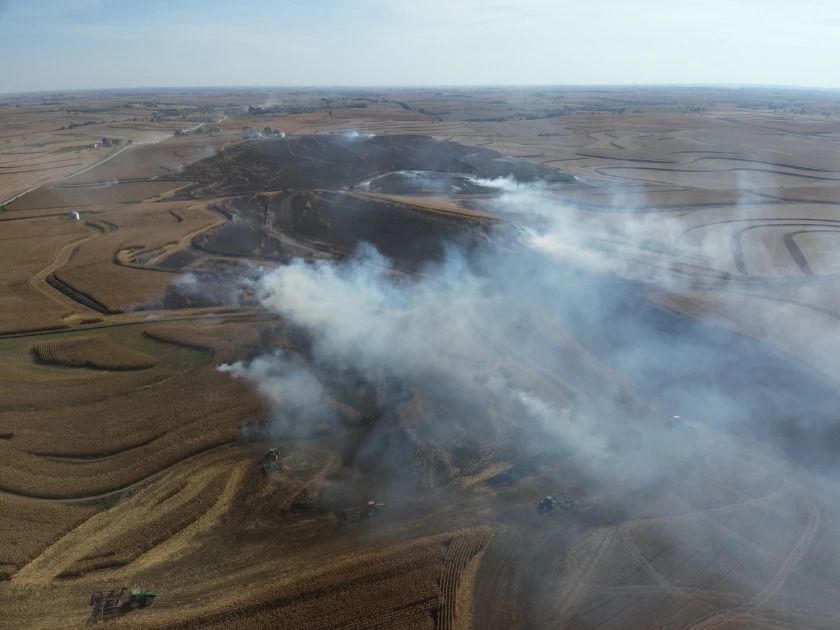 Smoke overtop hilly farmland