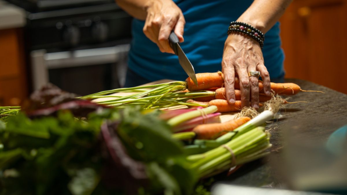 person cutting carrots