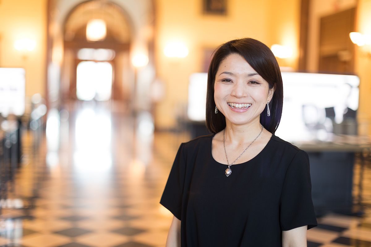  Portrait of Ai Hisano, smiling looking at camera, standing it a large hall