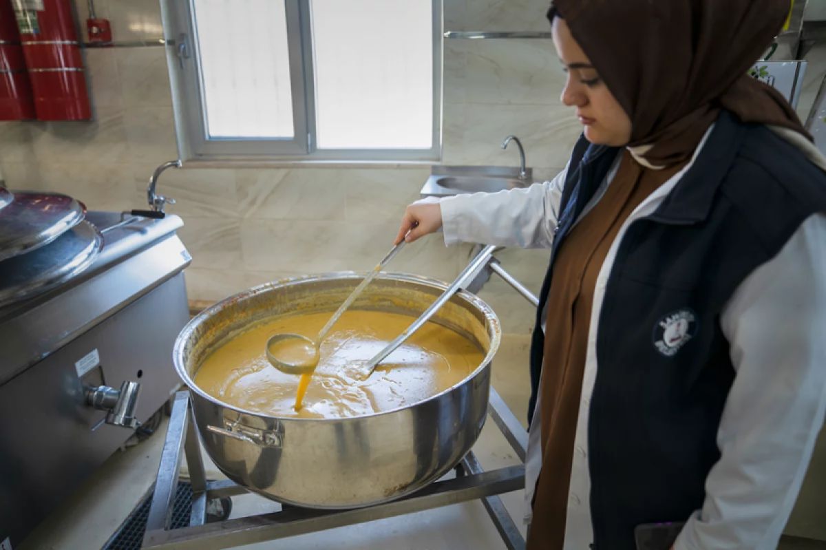 A woman making lentil soup