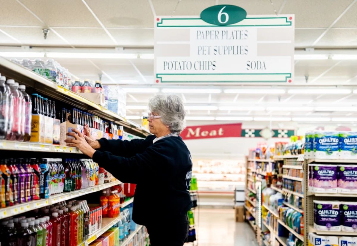 Sandy Munro stocking shelves at a market