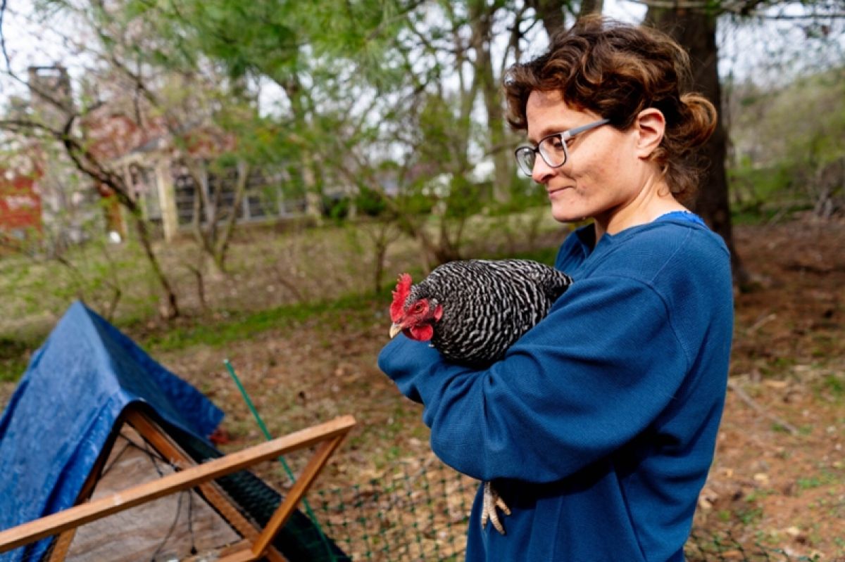 Leah shaffer holding a chicken from her flock