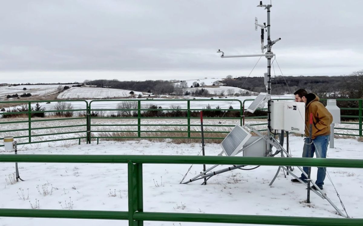 Regan Kerkman checking one of the Nebraska Mesonet weather stations 