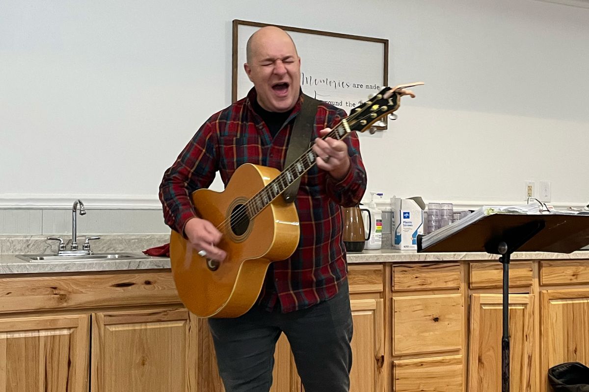 Nathan Dillon, playing guitar and singing hard