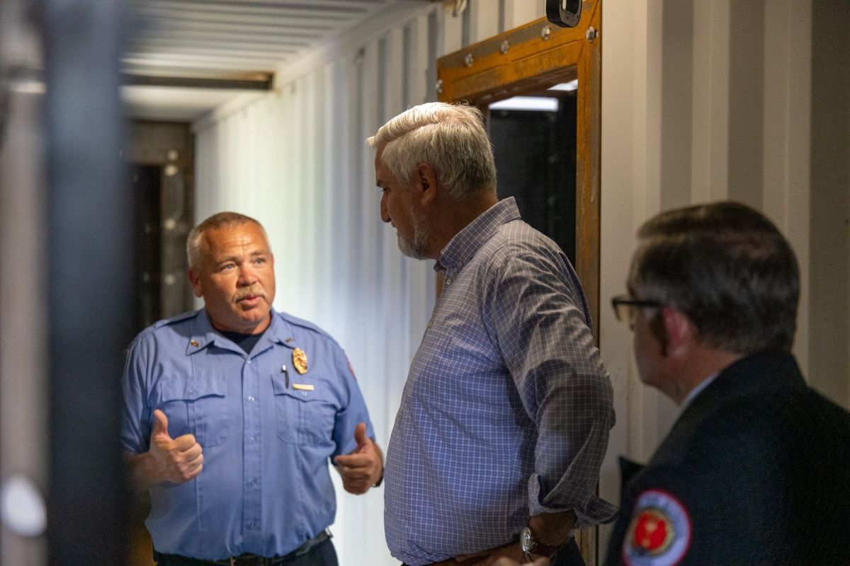 Gov. Eric Holcomb, center, speaks to an area firefighter at a Tuesday event. Indiana will build five new training sites for the state’s firefighters to address so-called training deserts.