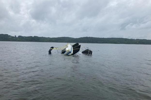 A Harbor Master houseboat sinks on Lake Monroe Saturday afternoon.