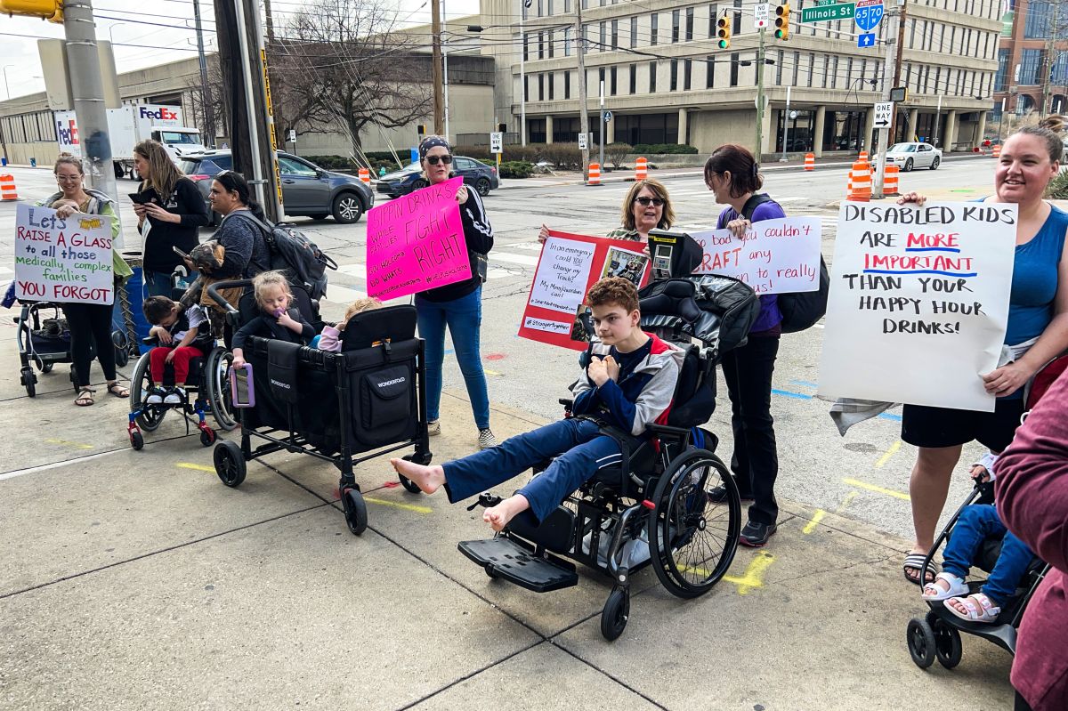 A parent protesting at the event said she doesn’t understand why the governor can make time for an event to celebrate legalizing happy hours, but can’t find time to respond to families about the “attendant care crisis.”