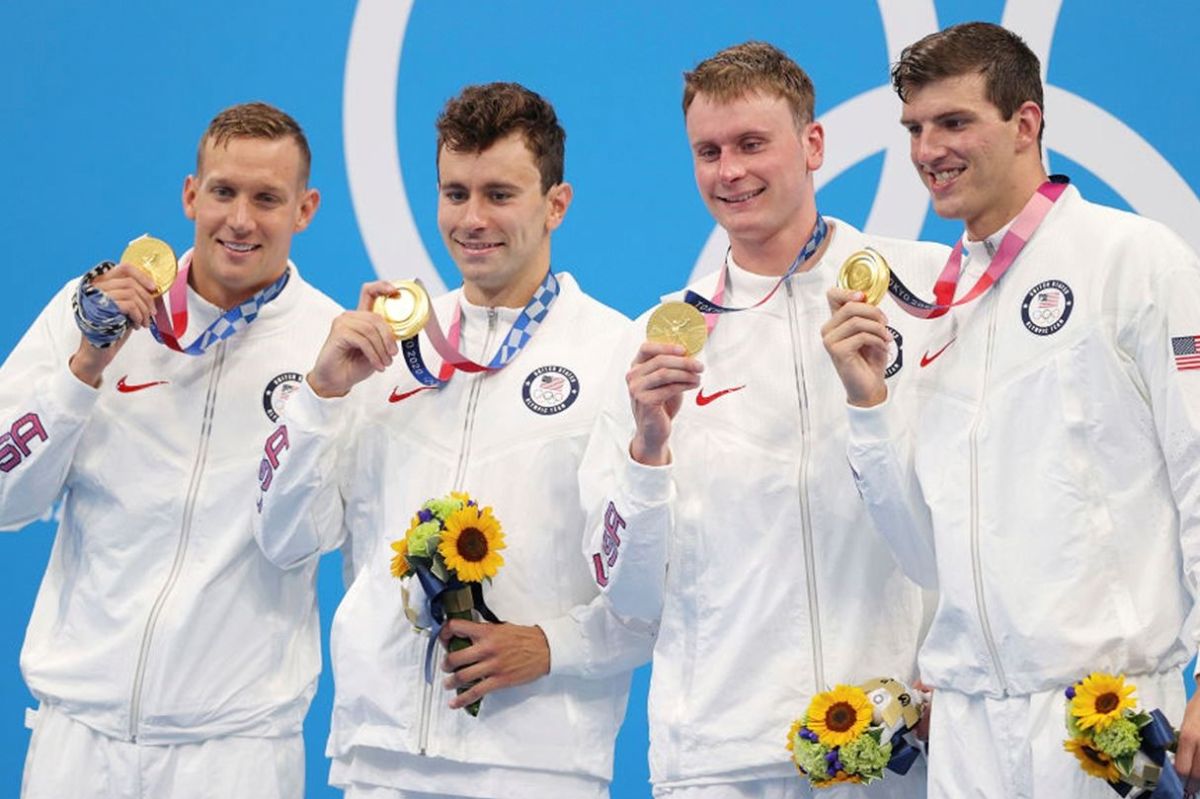 The United States' winning 400-meter freestyle relay team celebrates in Tokyo.