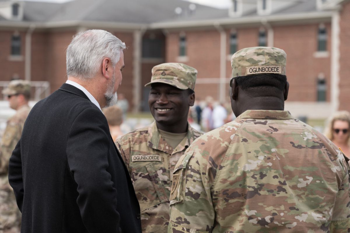 Gov. Eric Holcomb with two members of the Indiana National Guard