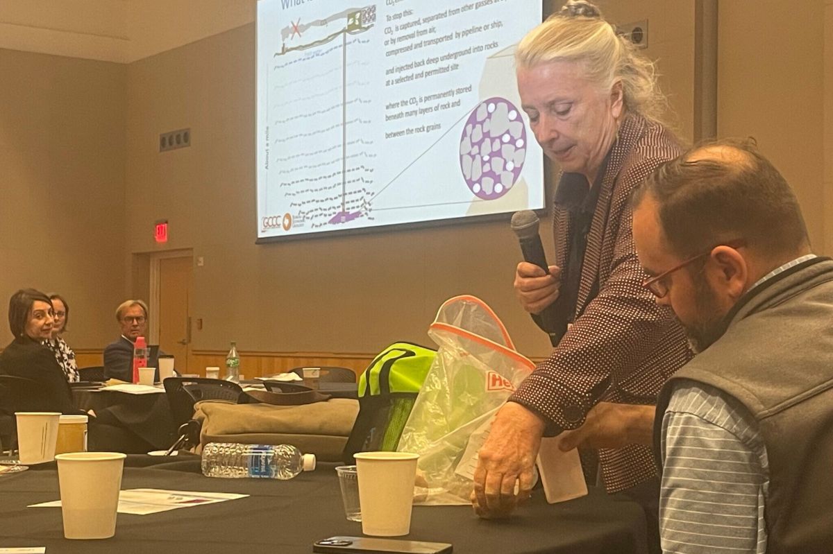 Susan Hovorka shows attendees how porous rock absorbs water