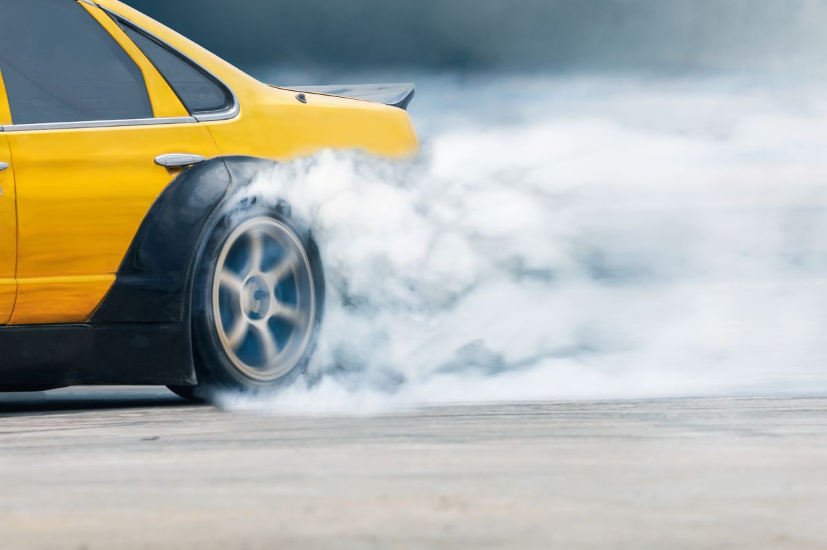 Race drift car burning tires on speed track