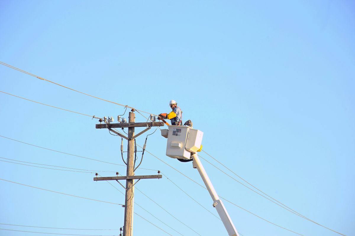 electrical worker fixes a power line