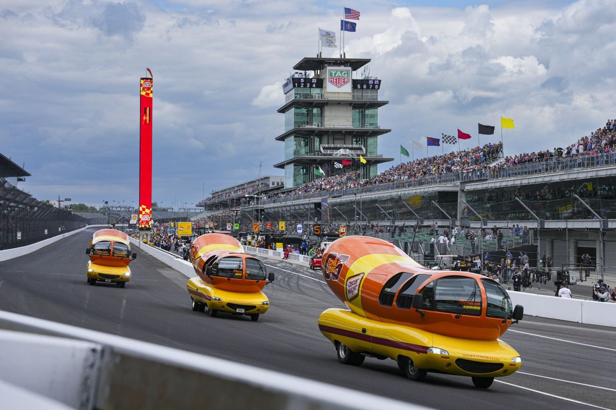 The Oscar Mayer Wienermobiles head into the first turn as they compete in the Wienie 500 following the practice session for the Indianapolis 500 auto race at Indianapolis Motor Speedway in Indianapolis, Friday, May 23, 2025. (AP Photo/Michael Conroy)
