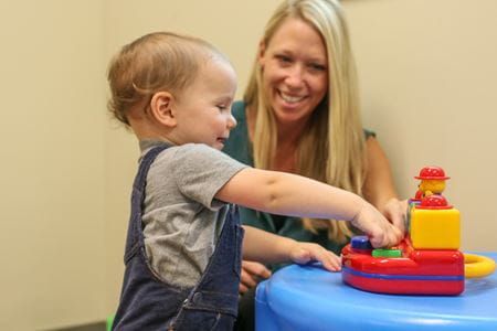 Rebecca McNally Keehn watches over a toddler at an Early Autism Evaluation Hub clinic.