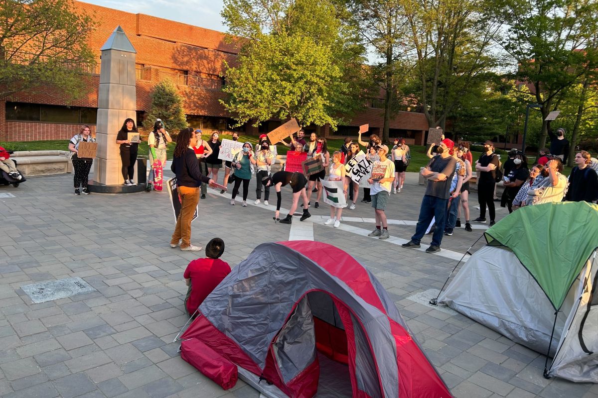 Students set up tents and chant with signs at Ball State University's "peace plaza" on May 1, 2024.