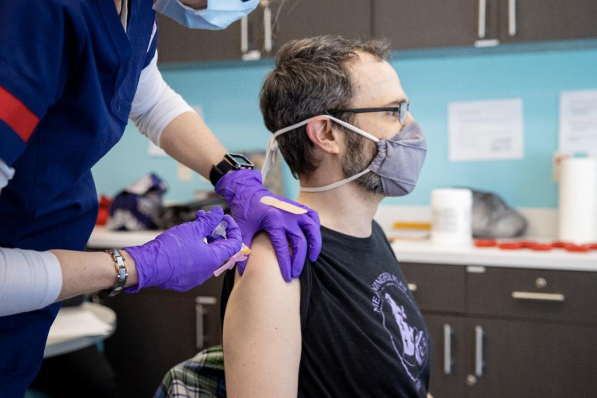 A person receives a COVID-19 vaccination at the Ball State University clinic location, operated by the Delaware County Health Department.