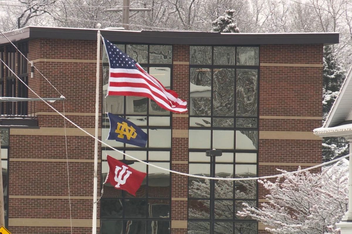 Dec. 20, 2024 - Notre Dame, IU flags fly beneath the American flag in South Bend, Indiana.