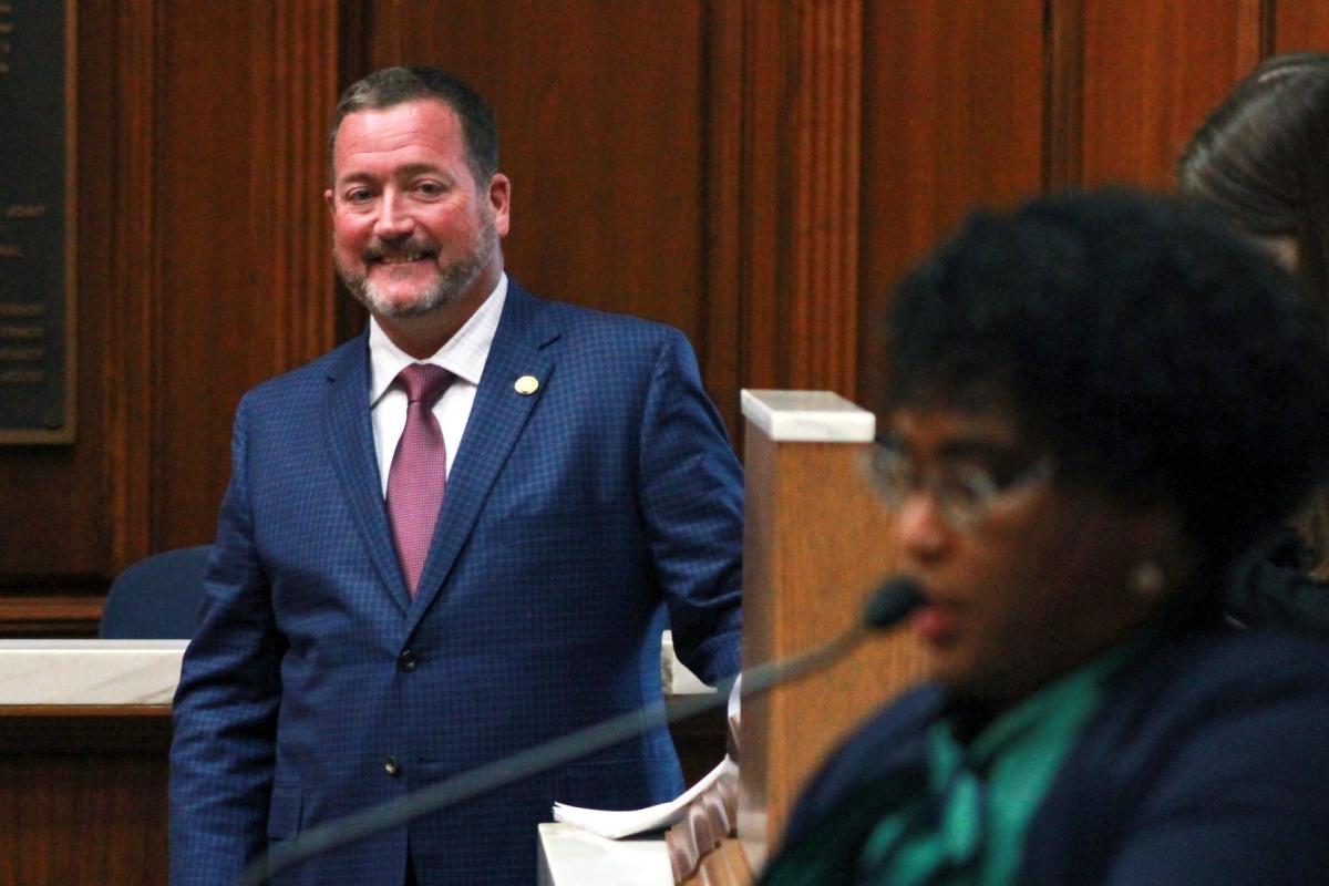 Rep. Chuck Goodrich (R-Noblesville), left, looks on as Rep. Cherrish Pryor (D-Indianapolis) speaks on the House floor on Monday about their bill to increase the state's earned income tax credit.