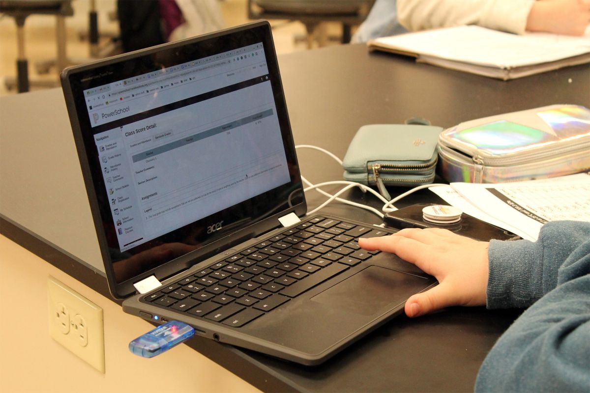 A student uses a laptop at a table.