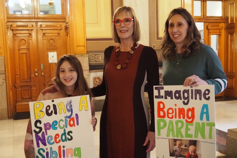  Lt. Gov. Suzanne Crouch poses with Tendra Duff and her 10-year-old daughter Kearsley on Jan. 29, 2024 in the Indiana Statehouse. The Duff family has 7-year-old twin boys, Trenin and Kaiden, who require 24/7 care that would be jeopardized 