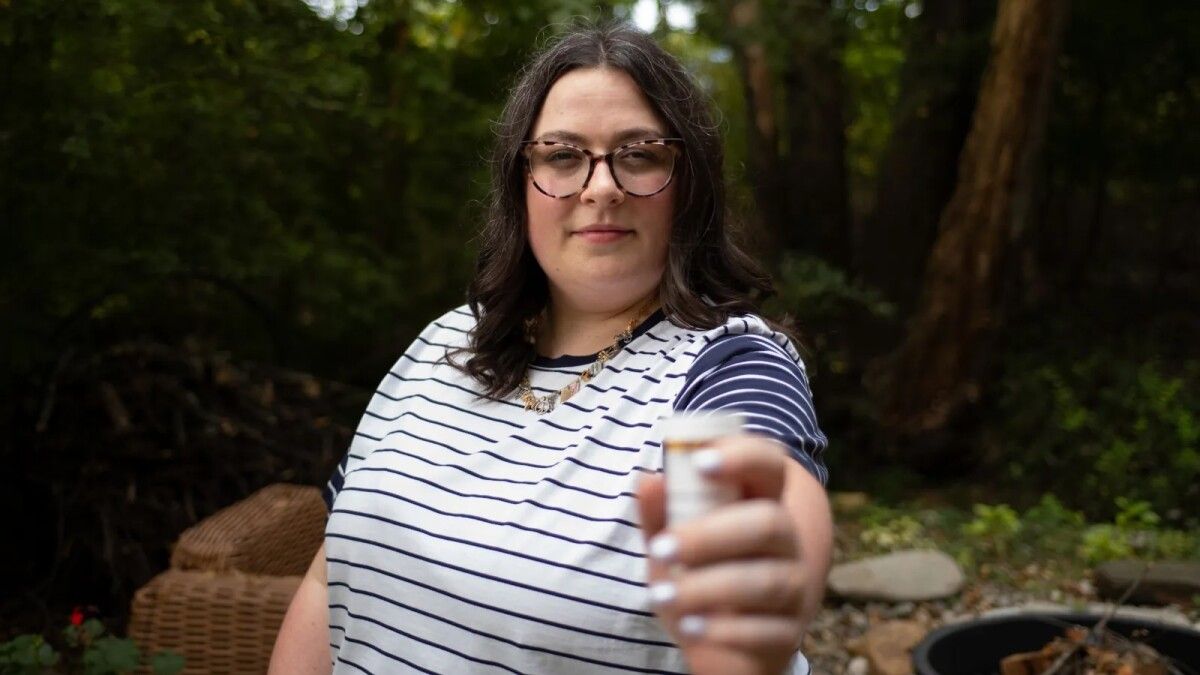 woman holding pill bottle