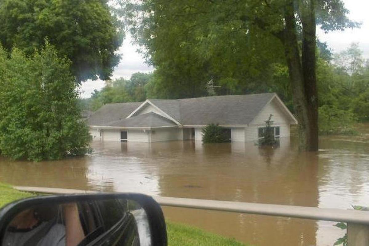 A home is half underwater from a flood in Johnson County. Prince's Lake dam breached during it, making the problem worse. 