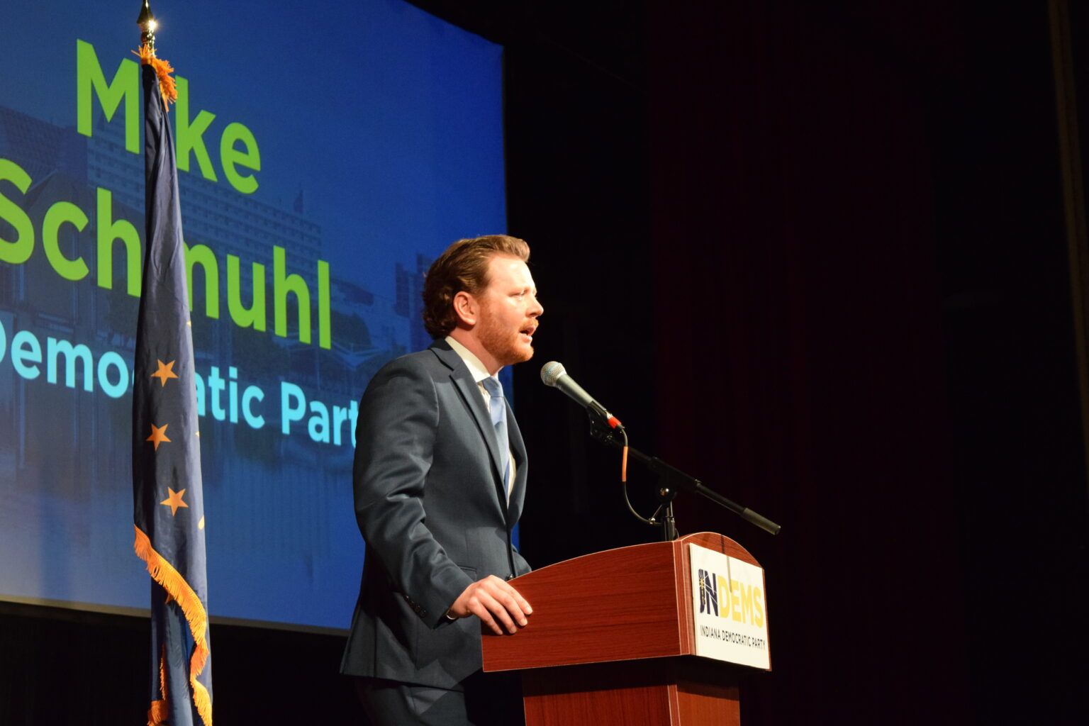 Indiana Democratic Party Chair Mike Schmuhl speaking at a podium