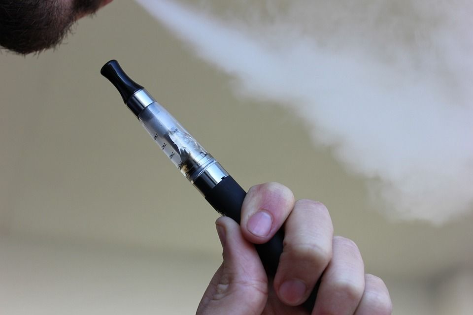 A stock image of a man using an e-cigarette.