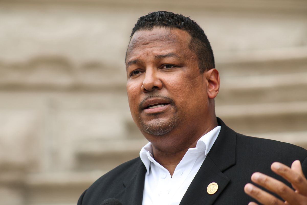 Earl Harris, Jr. is a Black man with black hair and goatee. He is wearing a black suit coat over a white shirt.