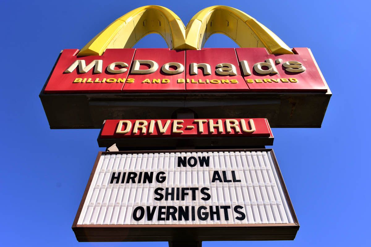 A McDonald's sign includes the message, Now Hiring All Shifts Overnights