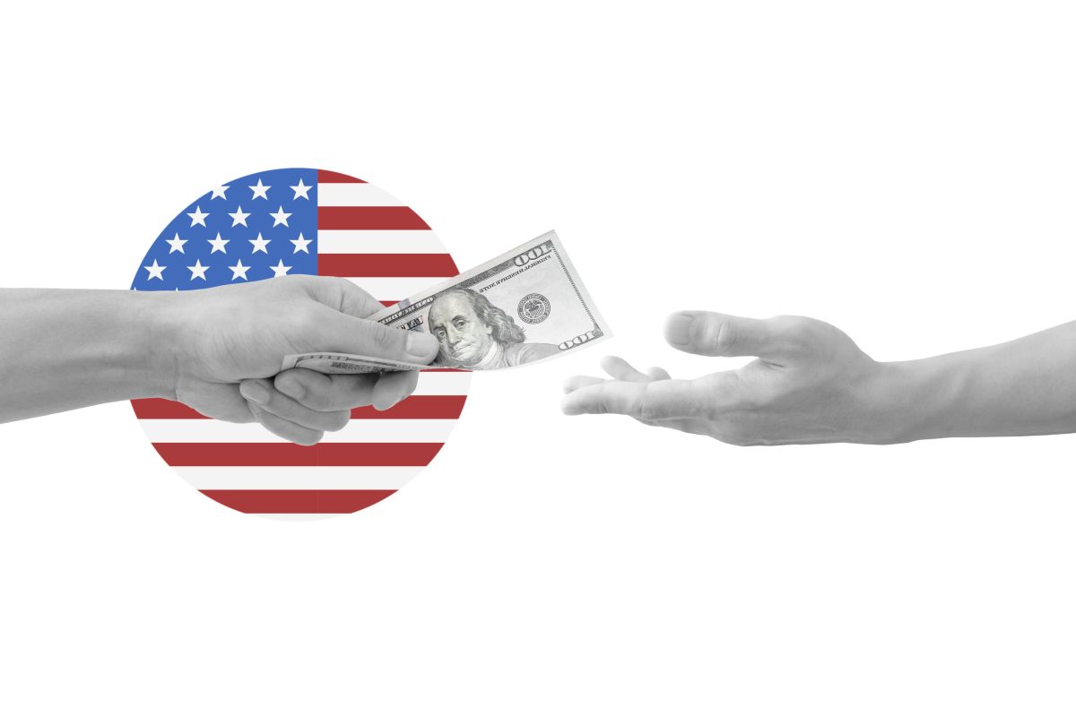 Hand giving and receiving money, with USA flag symbol, isolated on white background