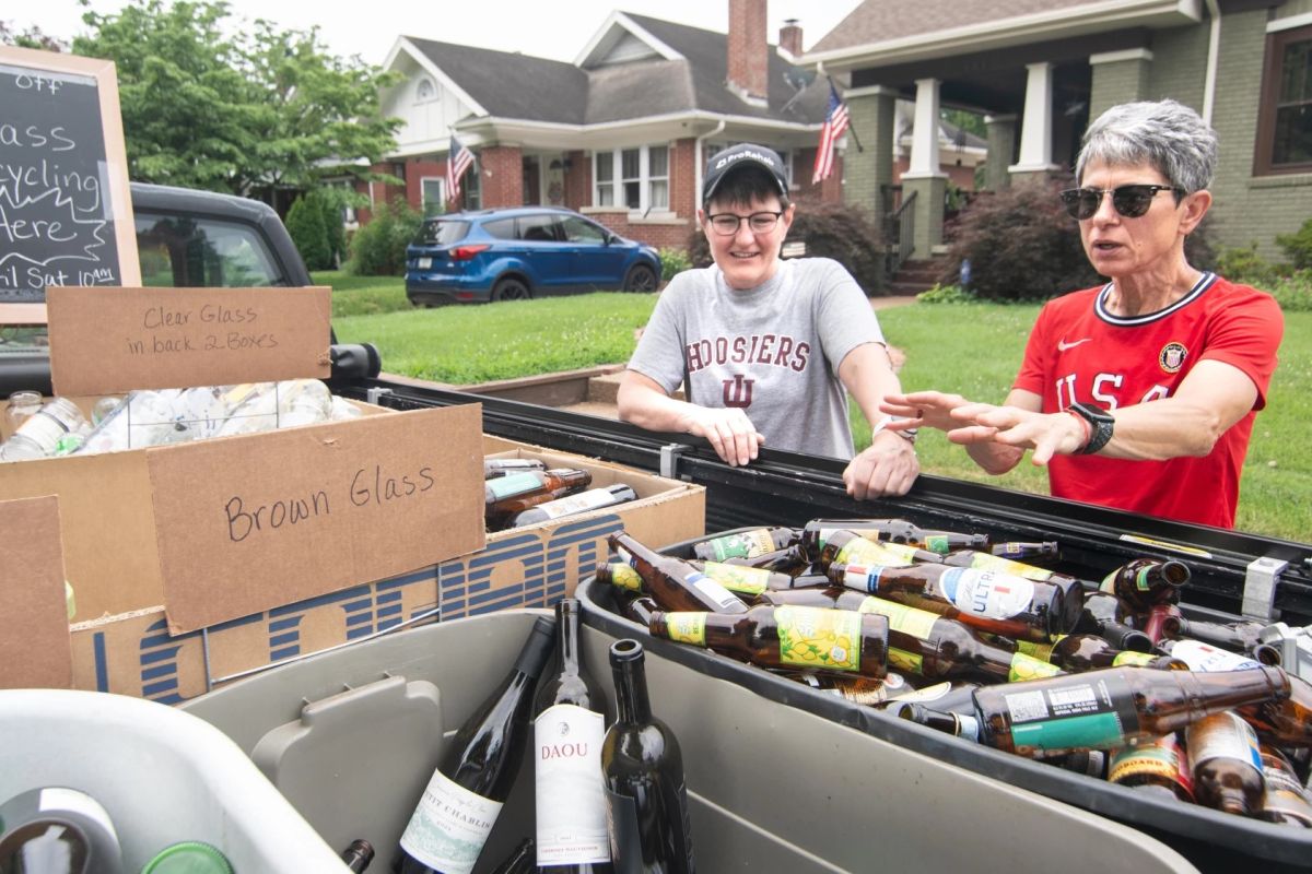 ulie Blevins (right) and Ann Basden finish loading a pickup truck full of glass bound for a facility in Posey county, which accepts outside glass as a courtesy. 